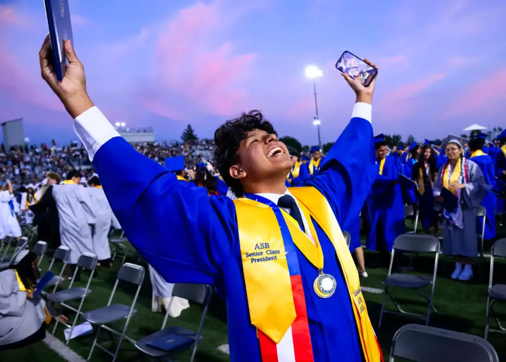 A graduate celebrates following the Valencia High School graduation ceremony...