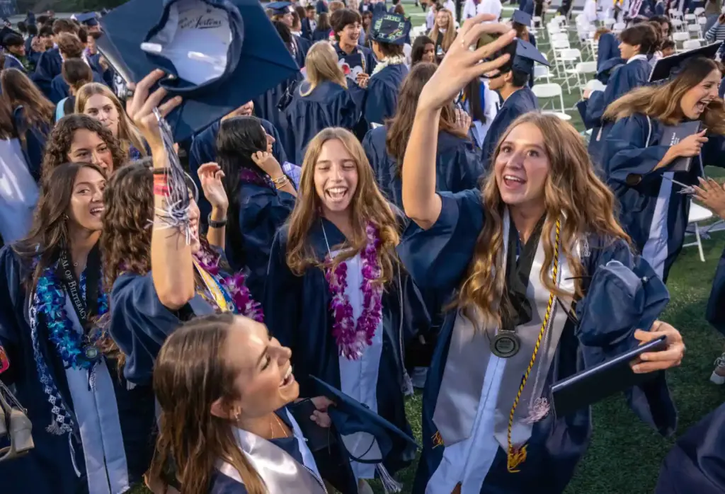 Friends celebrate together at the conclusion of their graduation ceremony...
