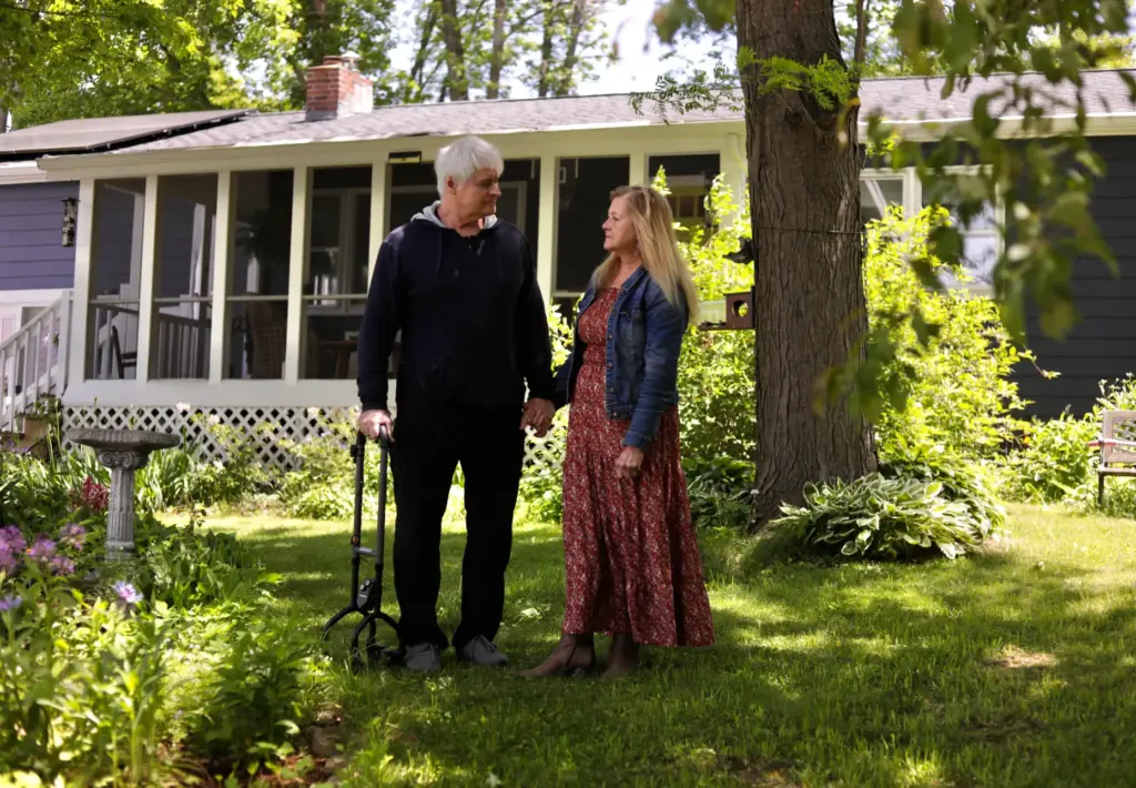 Ron McConnell stands in his front yard with his wife, Amy.