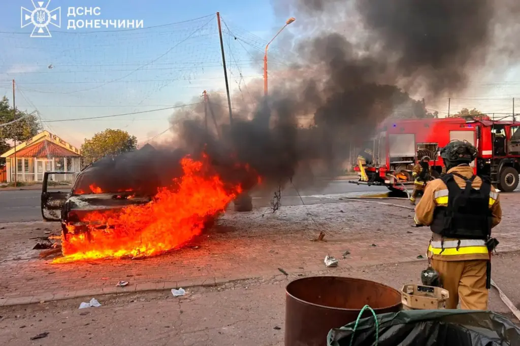 Emergency services personnel work to extinguish a fire after Russia's air attack.