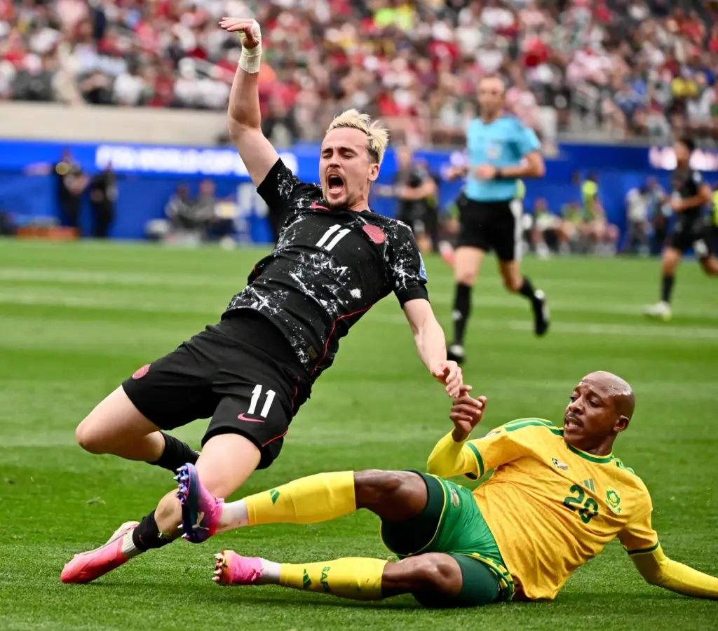 Canada midfielder Liam Millar (11) Is tripped up by South...