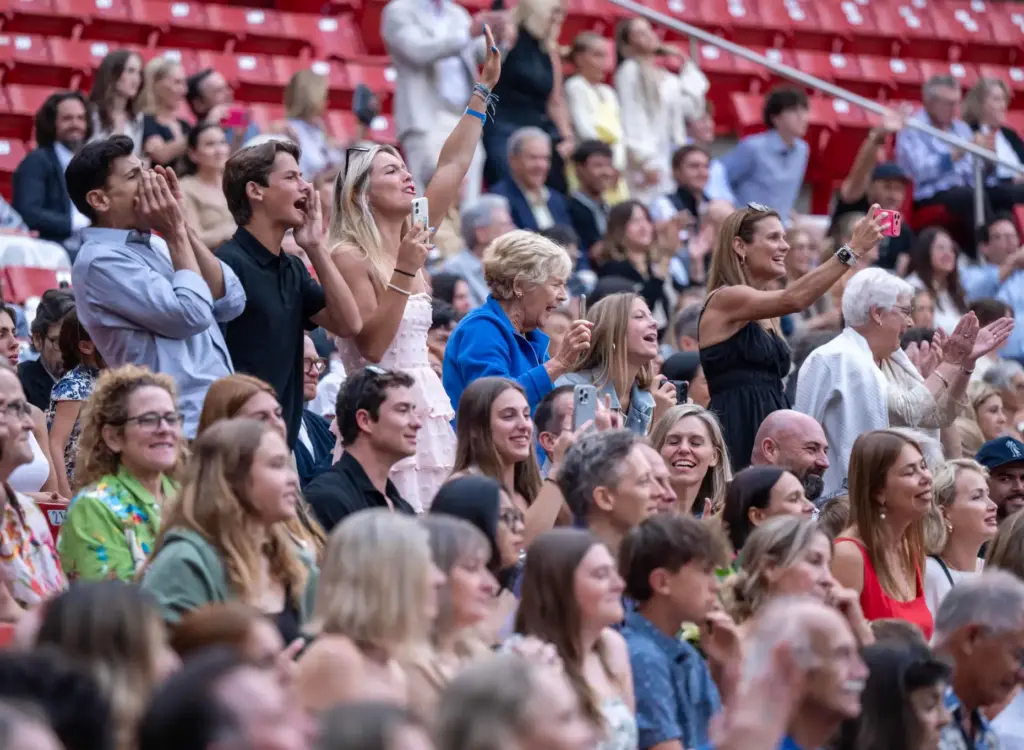 Family members cheer on as their graduateâs name is called...