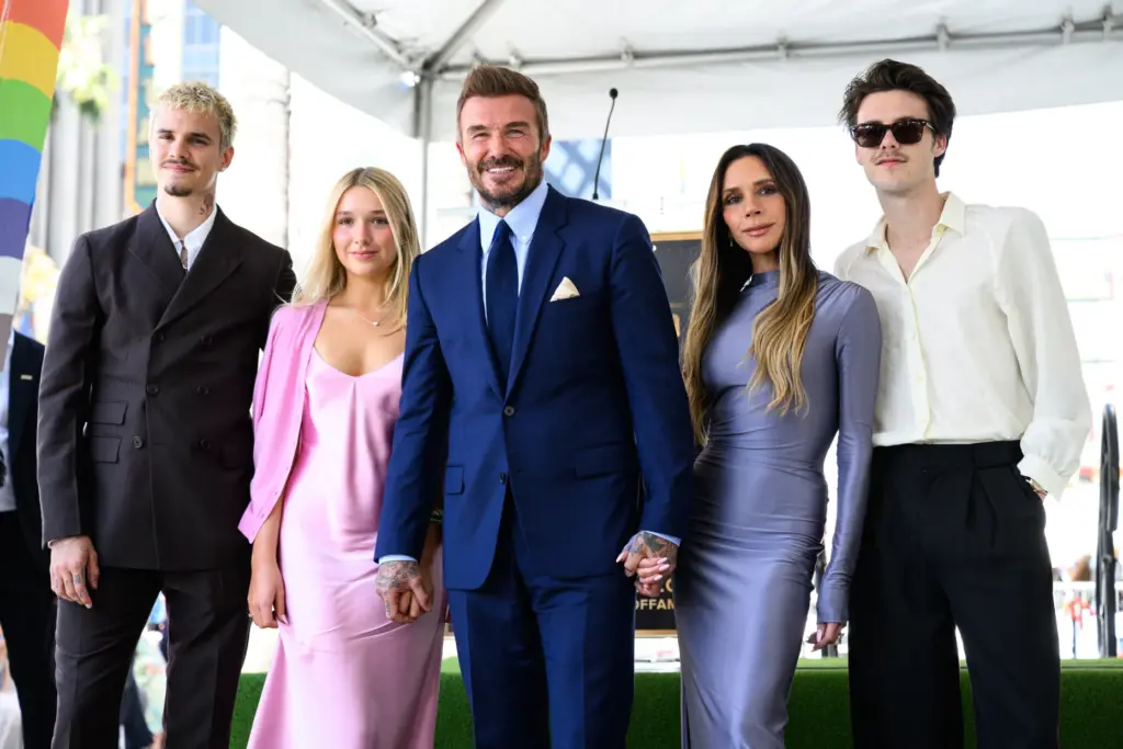 David Beckham poses with his wife Victoria and their children...