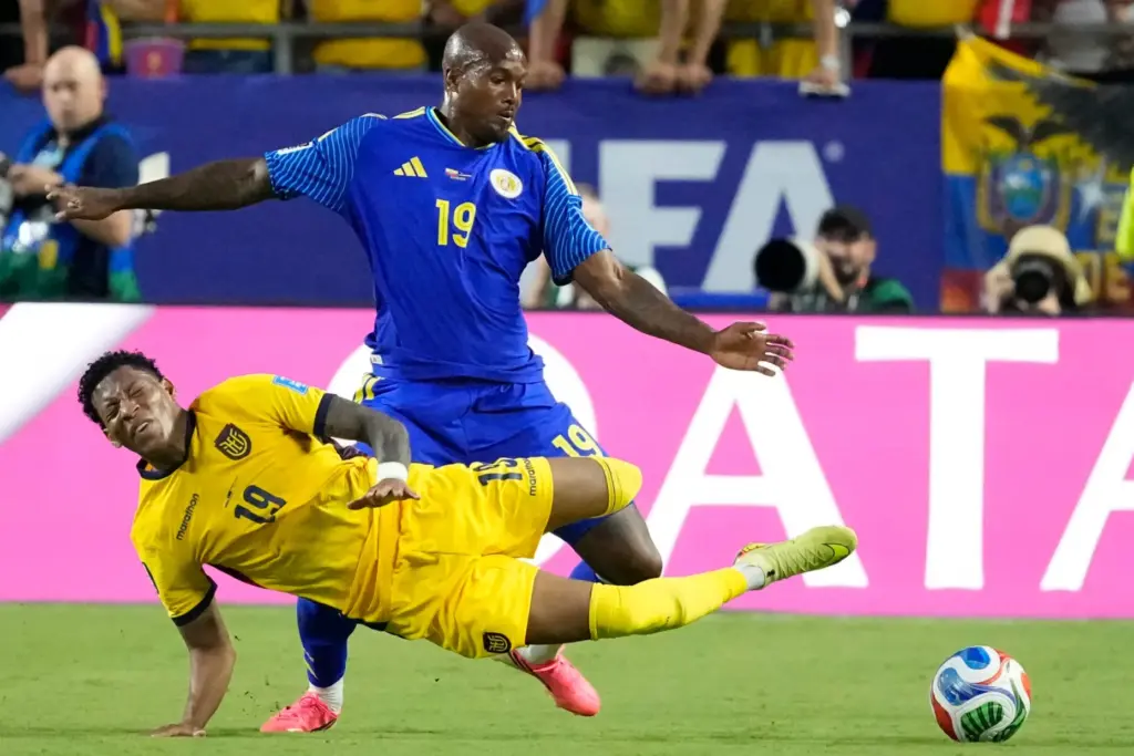 Ecuador’s Gonzalo Plata, bottom, falls after being fouled by CuraÃ§ao’s...