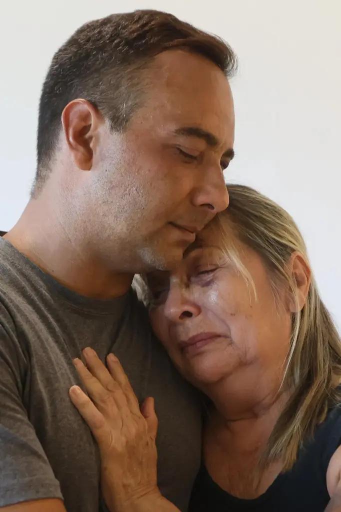 Grian Serrano embraces his mother Ingrid Rochabrun.