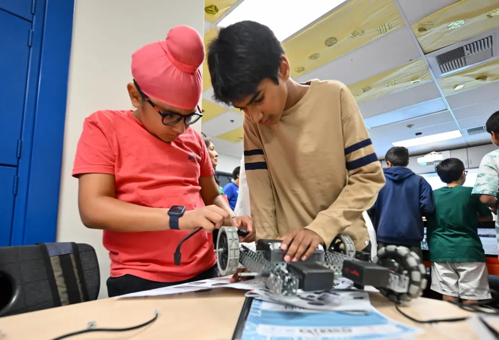 Mehtaab Sethee, left, and Ayaan Shah work on a robot...