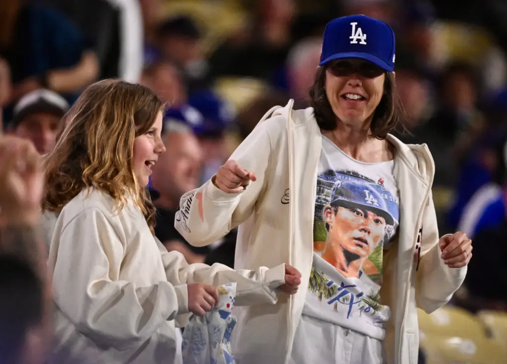 A Dodger fan wearing a Yoshinobu Yamamoto #18 of the...