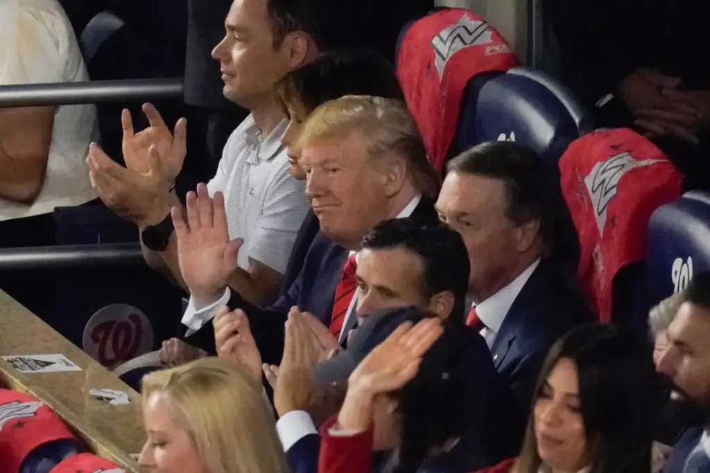 FILE – President Donald Trump watches during the first inning...