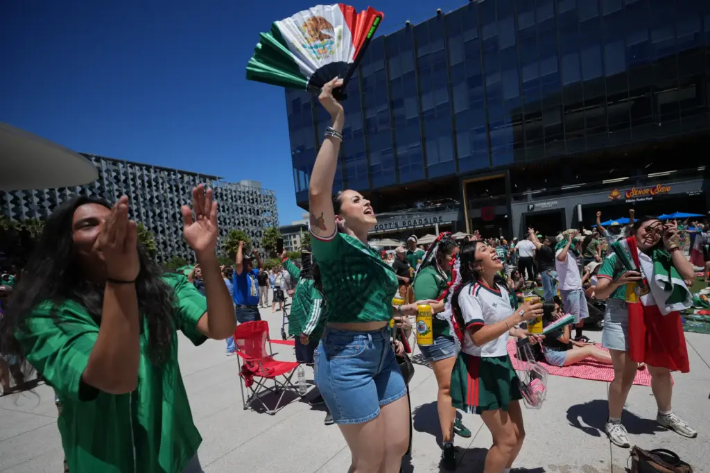 Mexico fans celebrate their team’s first goal against South Africa...