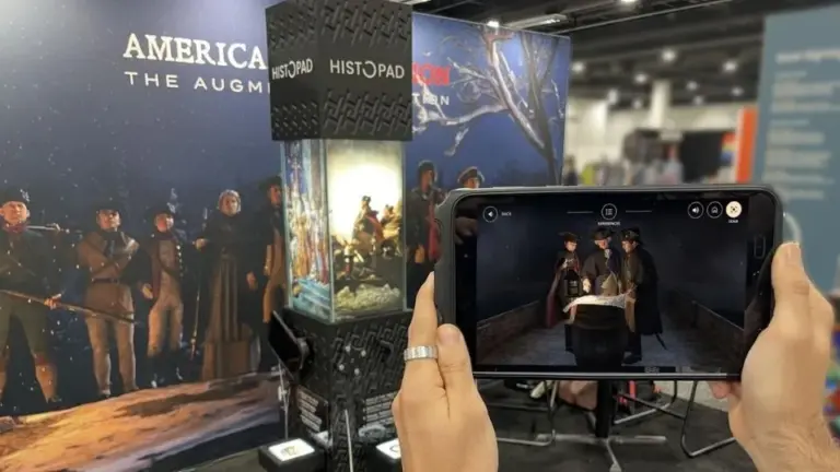 A visitor holds a touch screen tablet to view 3D...