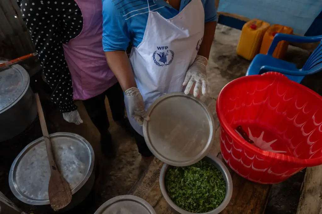 Cooks prepare meals for Ebola patients at the Evangelical Medical...