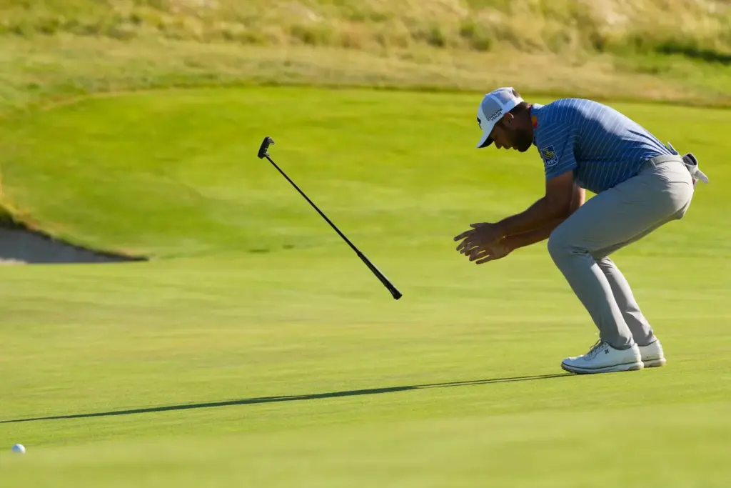 Sam Burns reacts after missing a putt on the 18th...
