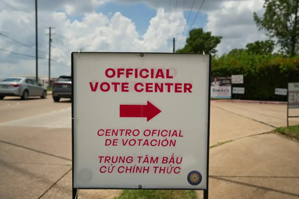 A sign stands outside a polling location during local and...
