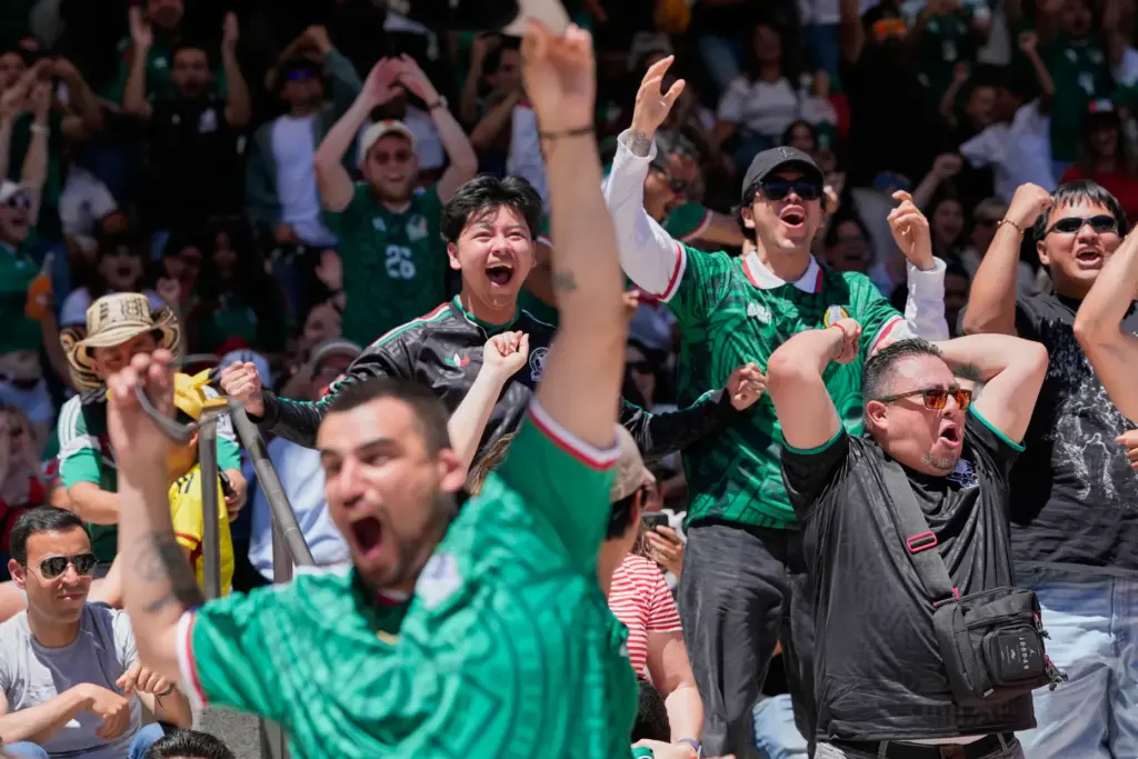 Mexico fans celebrate their team’s first goal against South Africa...