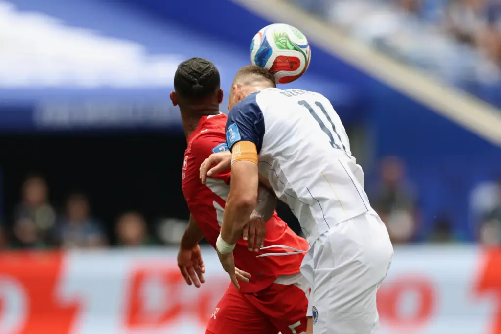 Bosnia and Herzegovina forward Edin DÅ¾eko (11) heads the ball...