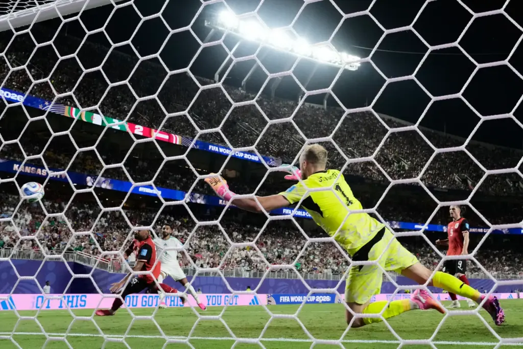Algeria’s Riyad Mahrez (7) scores their second goal past Austria...