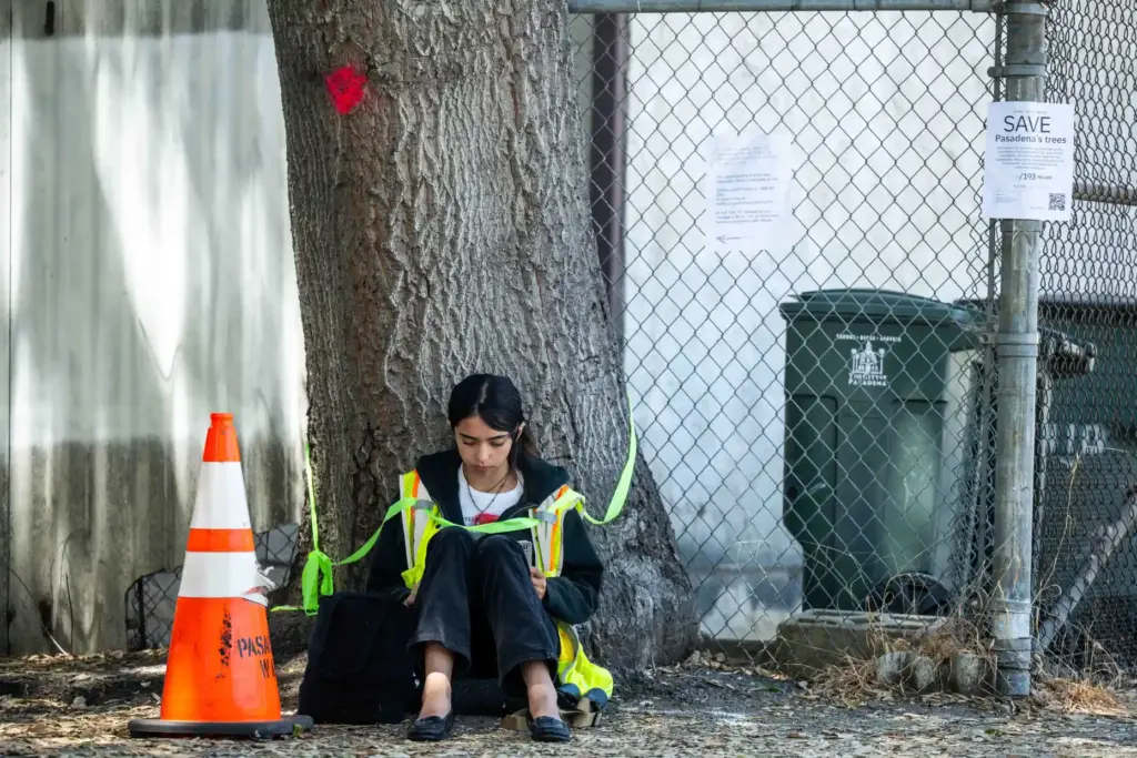 Tied to an oak Paloma Muniz-Ochoa, 17, of Pasadena, reads...