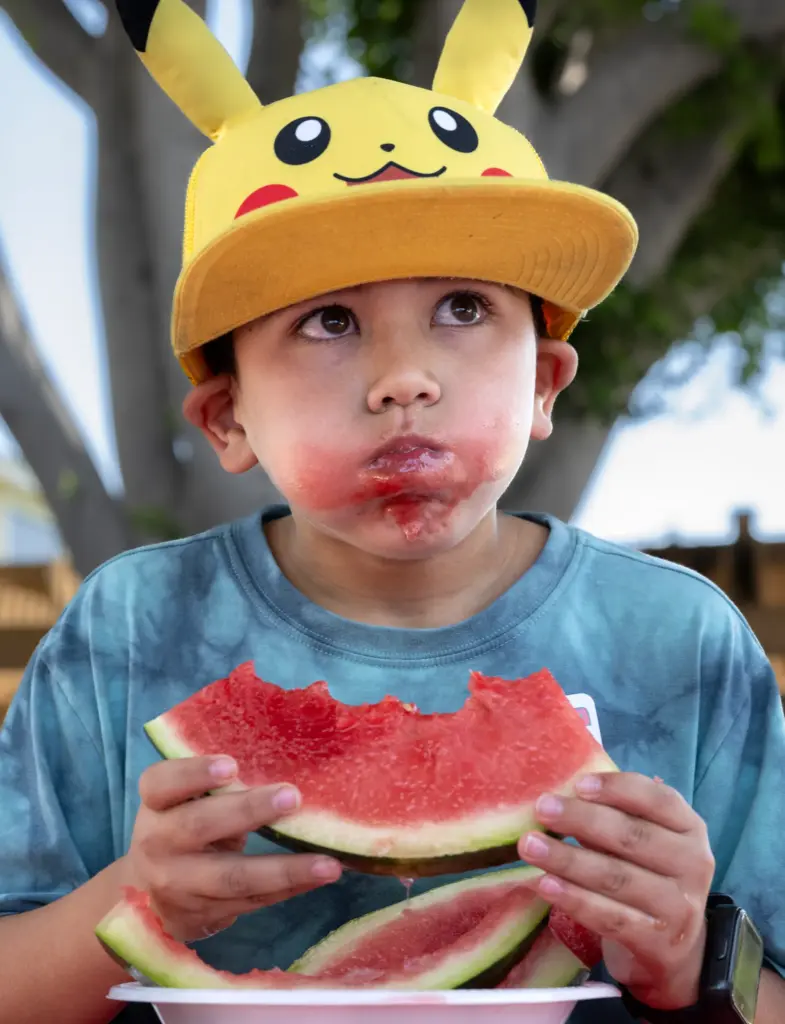 Jeff Bowers, 8, competes in the watermelon-eating contest during the...