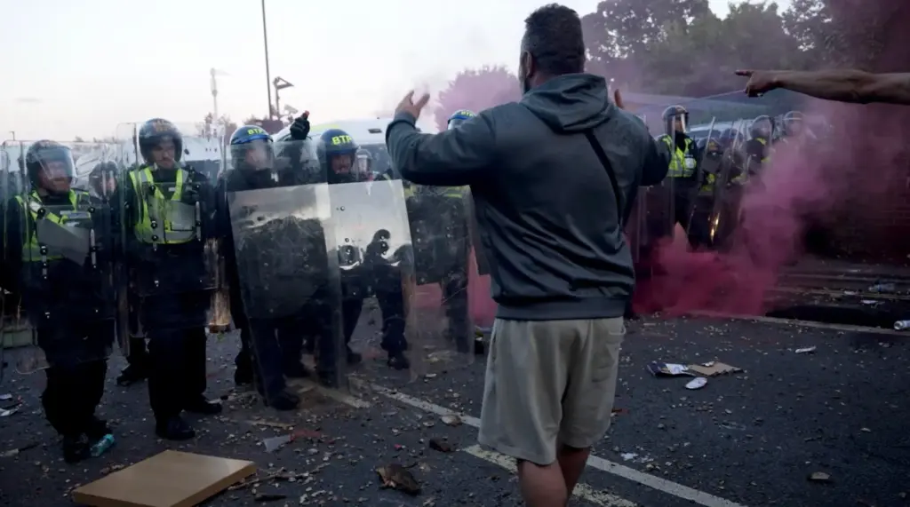In this image taken from PA Video, police and protestors...