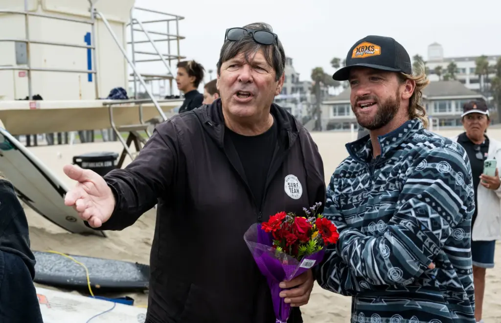Huntington Beach High School surfing coach Andy Verdone, left, talks...