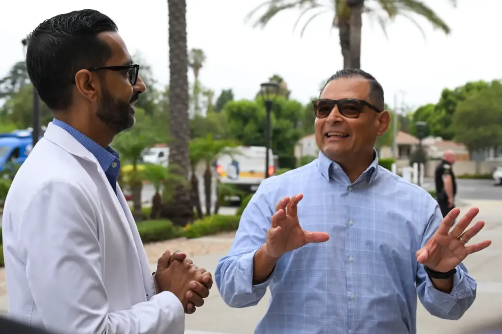 George Rojas, right, reunites Thursday, June 18, 2026, with Dr....