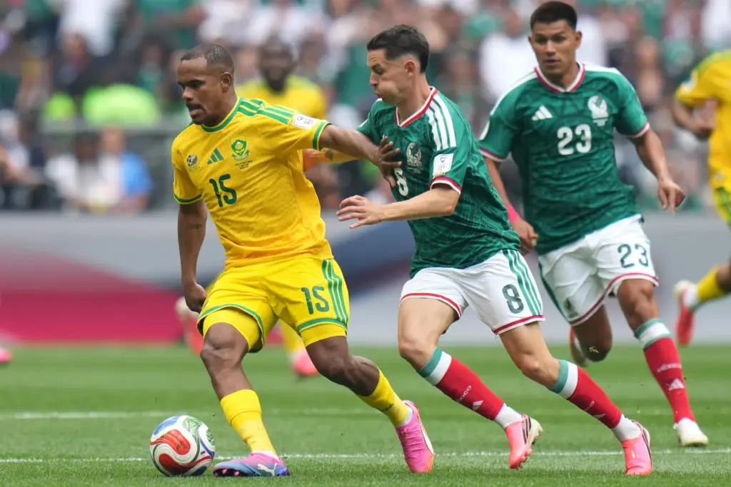 South Africa’s Iqraam Rayners, left, controls the ball against Mexico’s...