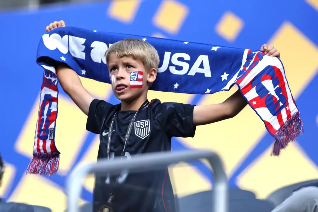 A United States fan holds up a scarf before the...