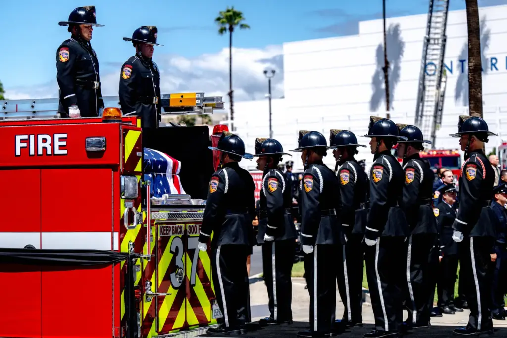 The flag-draped casket of Cal Fire Capt. Tim Rodriguez arrives...