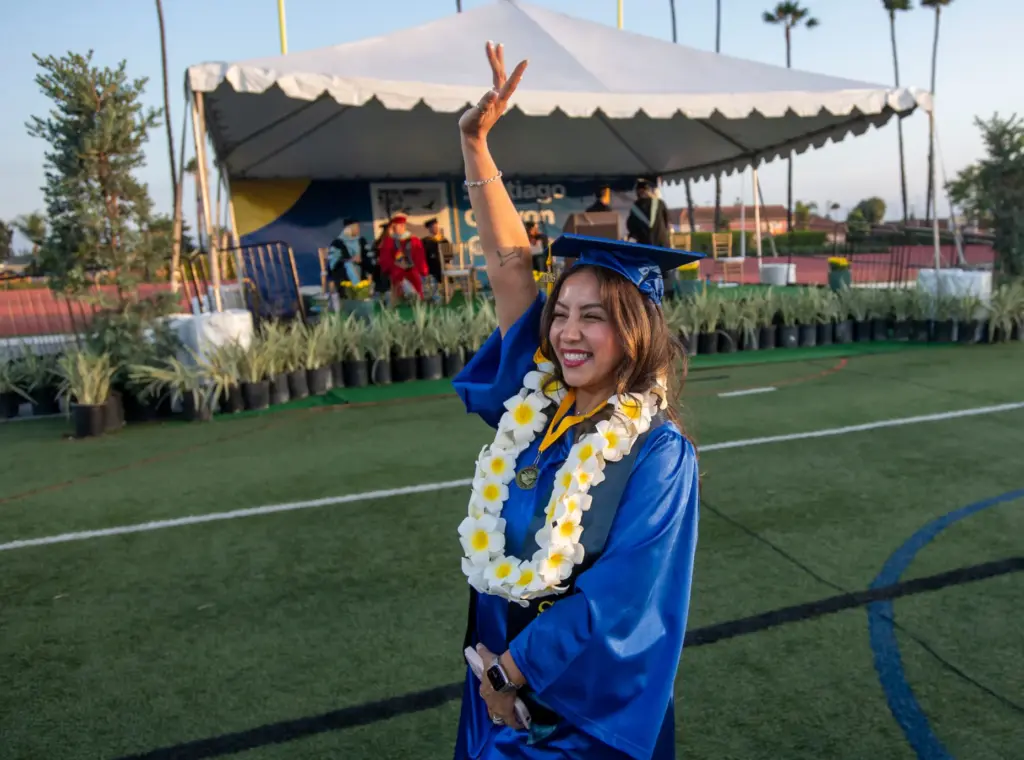 School of Continuing Education Studentâs speaker Laura Moncada waves to...