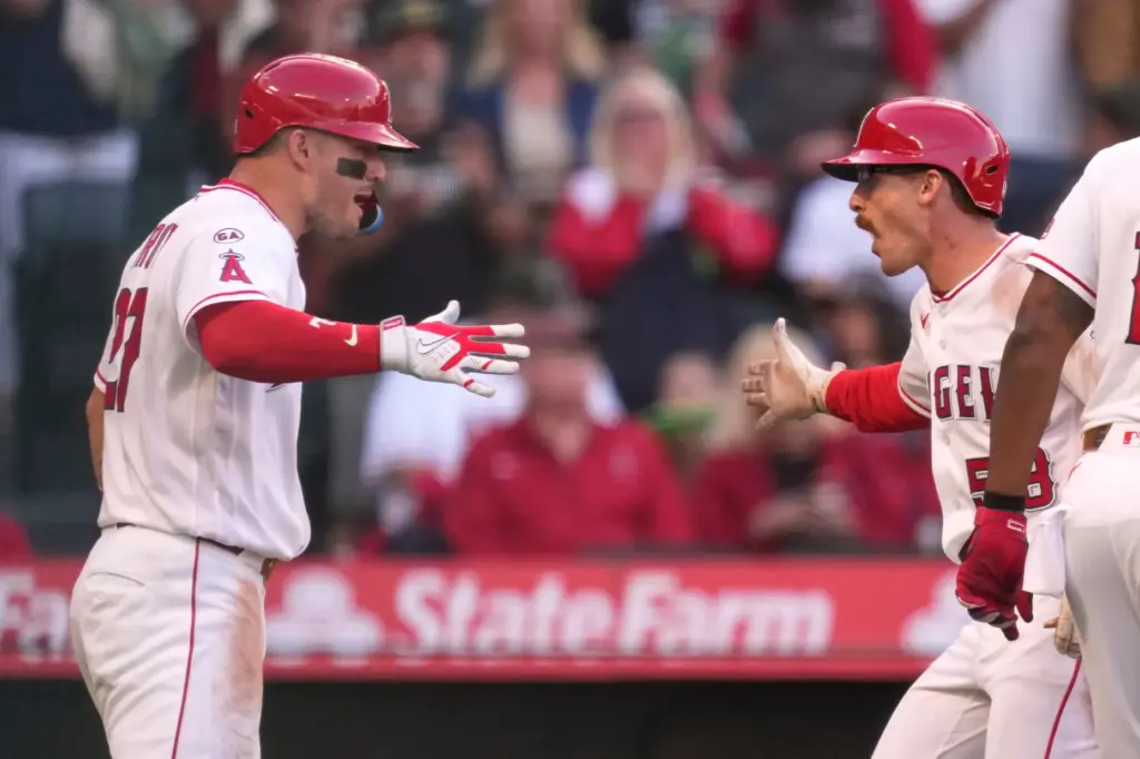 The Angels’ Wade Meckler, right, is congratulated by teammate Mike...
