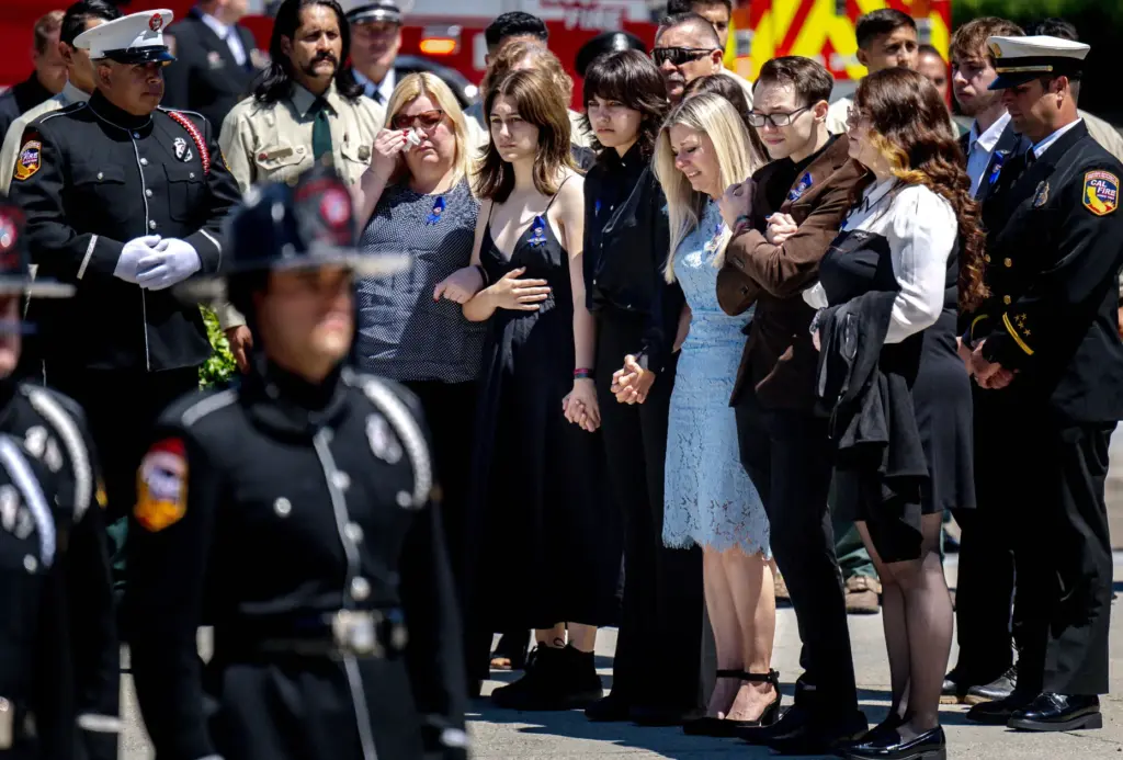Family members, including his wife Dorothy at the center, along...