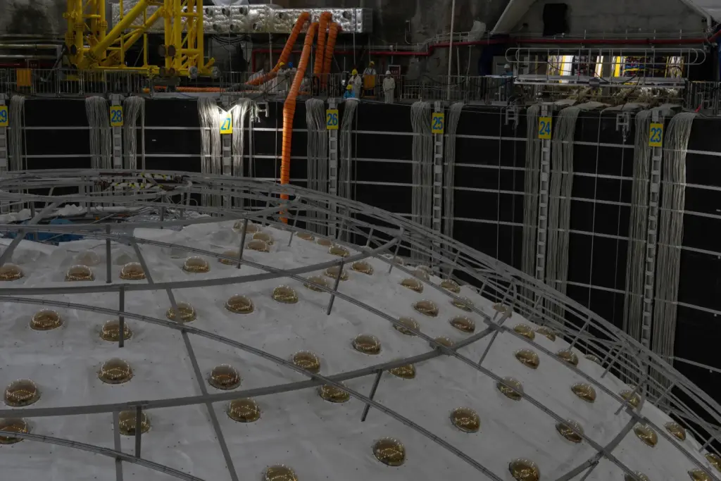 FILE – Workers labor near the cosmic detector housed underground...