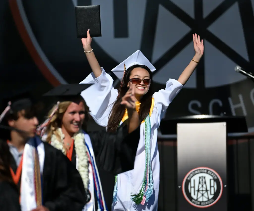 Mindy Blair Pham celabrates after receiving her diploma during the...
