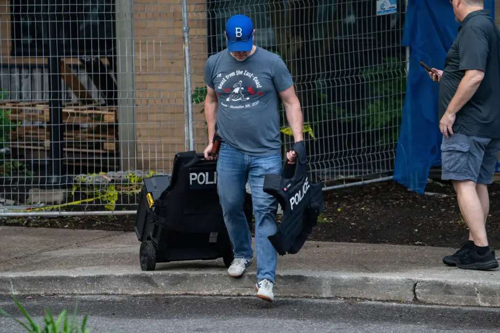 Investigators work the scene where a Toronto Police officer was...