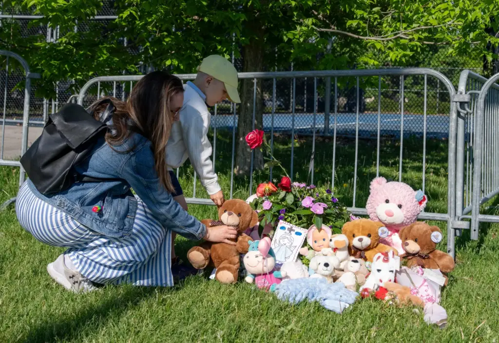 A young boy an his mother leave a teddy bear...
