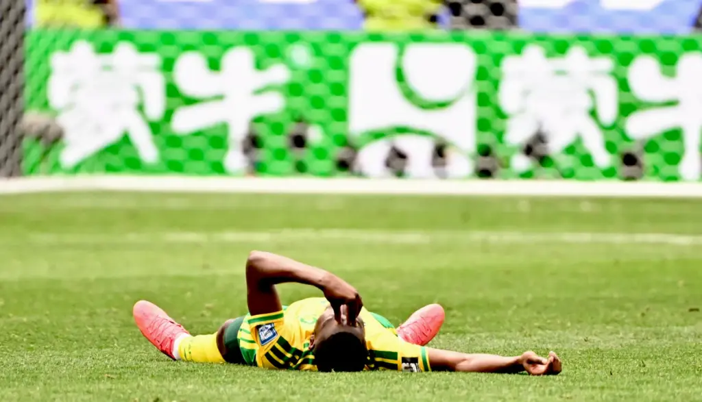 South Africa defender Aubrey Modiba (6) lays on the pitch...