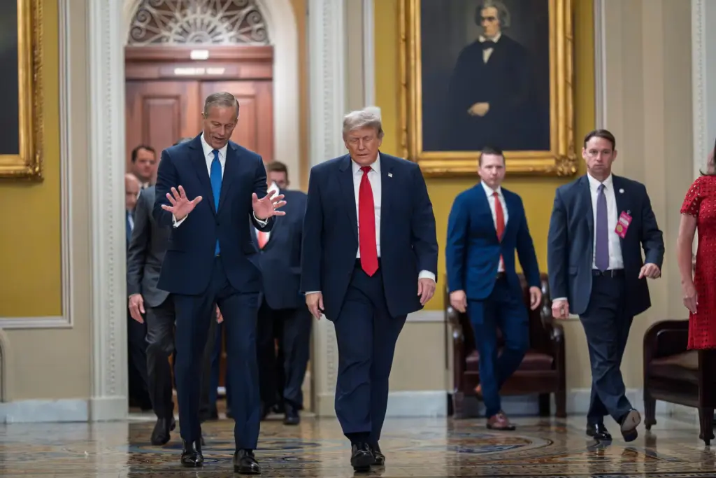 President Donald Trump, escorted by Senate Majority Leader John Thune.