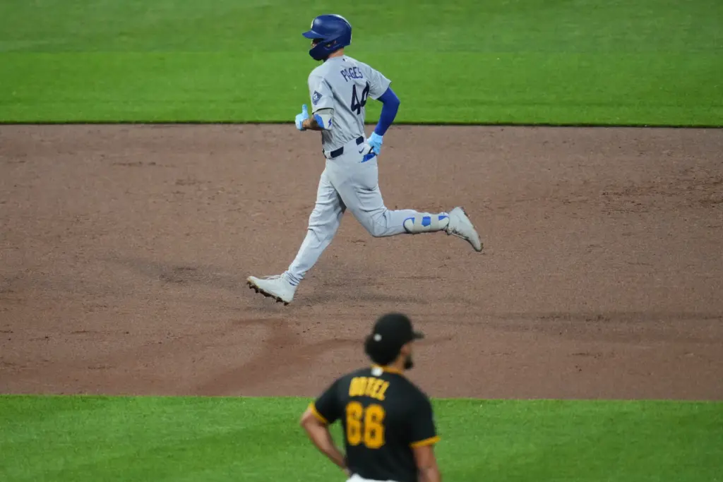 The Dodgers’ Andy Pages, top, runs the bases after hitting...