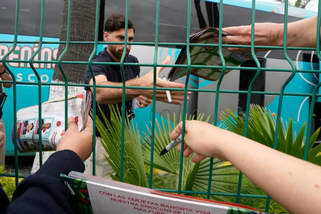 Iran’s Alireza Jahanbakhsh greets fans and signs autographs as the...