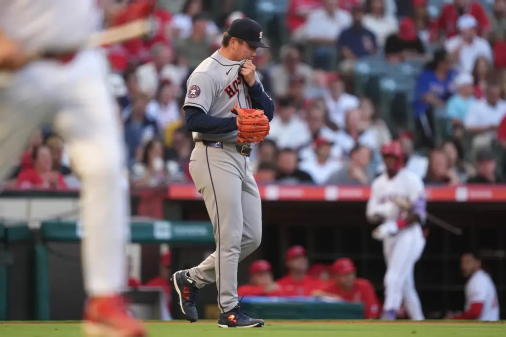 Houston Astros starting pitcher Kai-Wei Teng walks back to the...