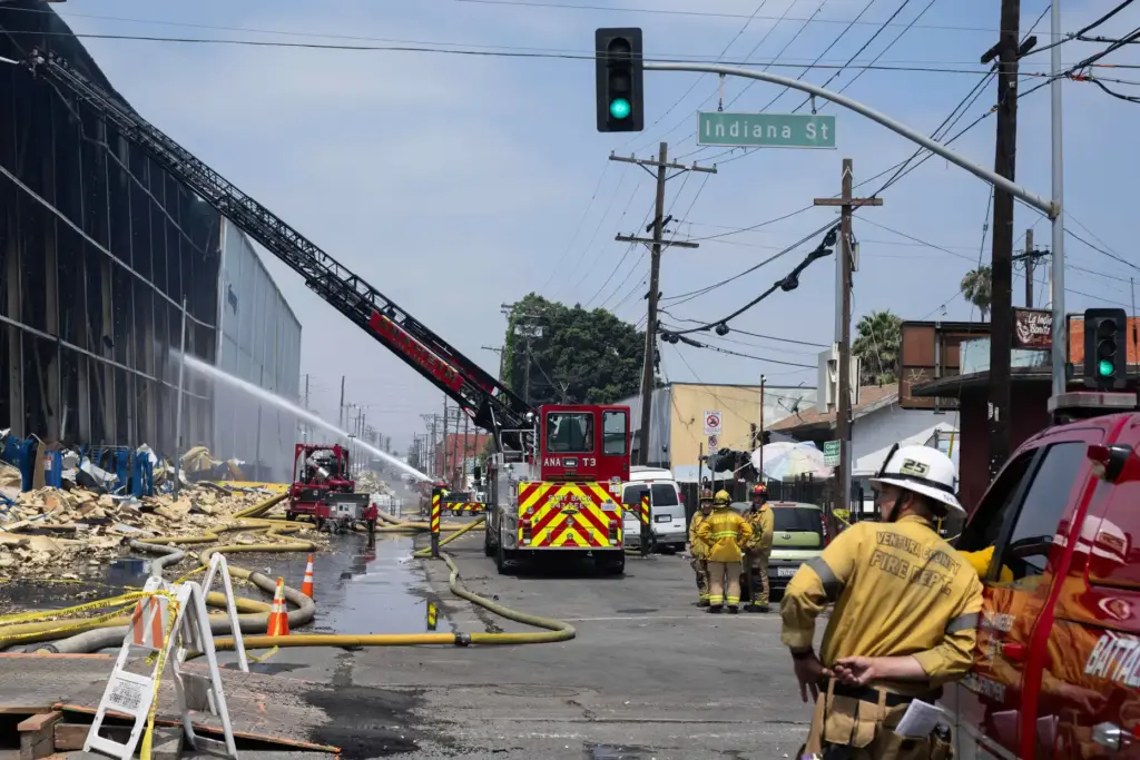 Firefighters and emergency crews continue to extinguish a massive fire...