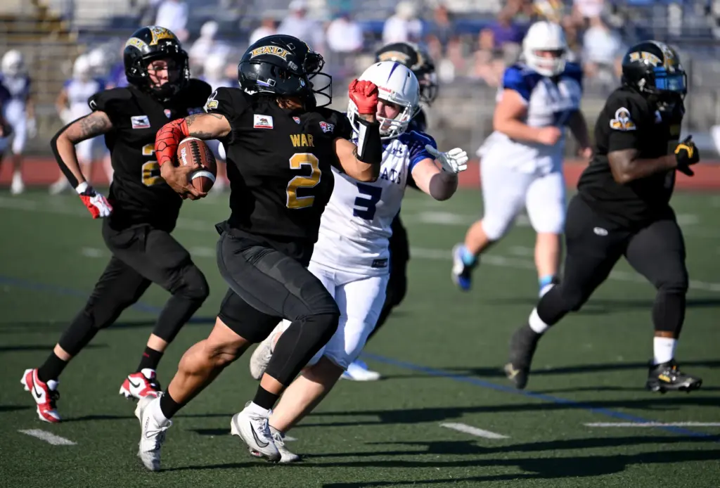 Cali War’s Sonfre Roberson carries the ball for yardage against...