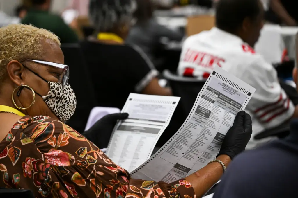 Temporary election assistants process vote-by-mail ballots Monday, June 1, 2026,...