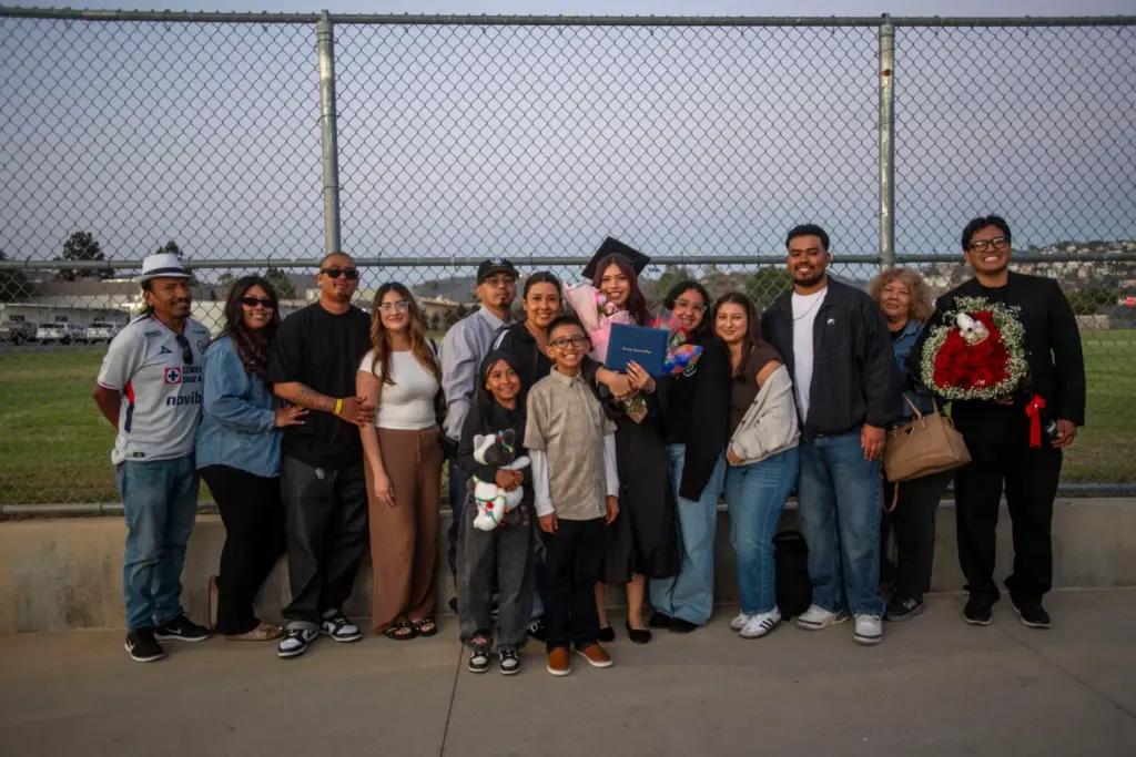 Biology major Ashley Fuerte-Mejia is surrounded by family after Santiago...