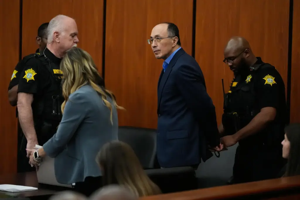 Chikei Rick Chow is escorted out of the courtroom during closing arguments.