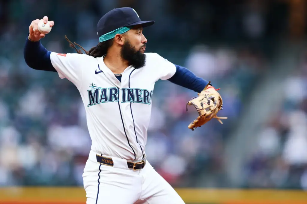 Seattle Mariners shortstop J.P. Crawford throws to first base during...
