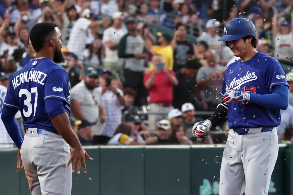 Dodgers star Shohei Ohtani, right, celebrates with teammate Teoscar HernÃ¡ndez...