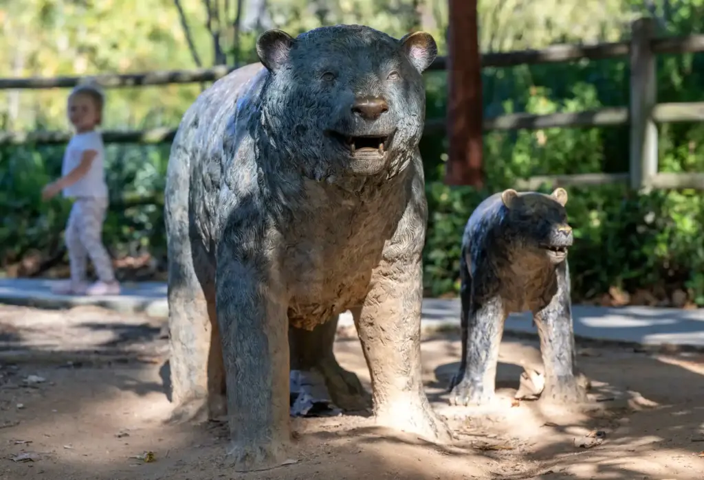 Life-sized copper sculptures depicting a bear mother and cub sit...