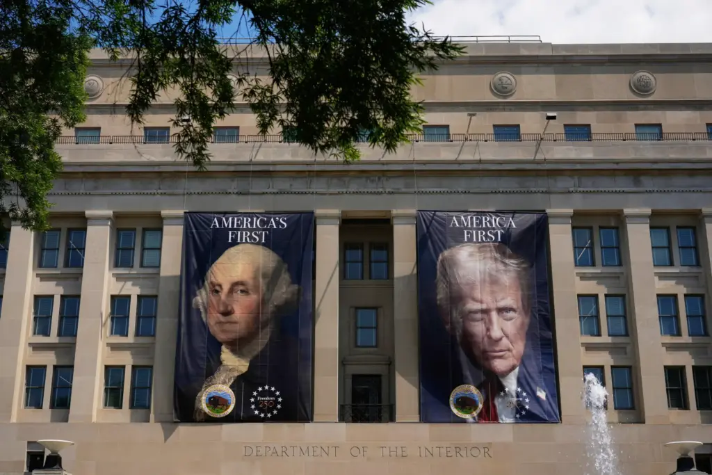 Banners, one of President George Washington that reads “America’s First,”...