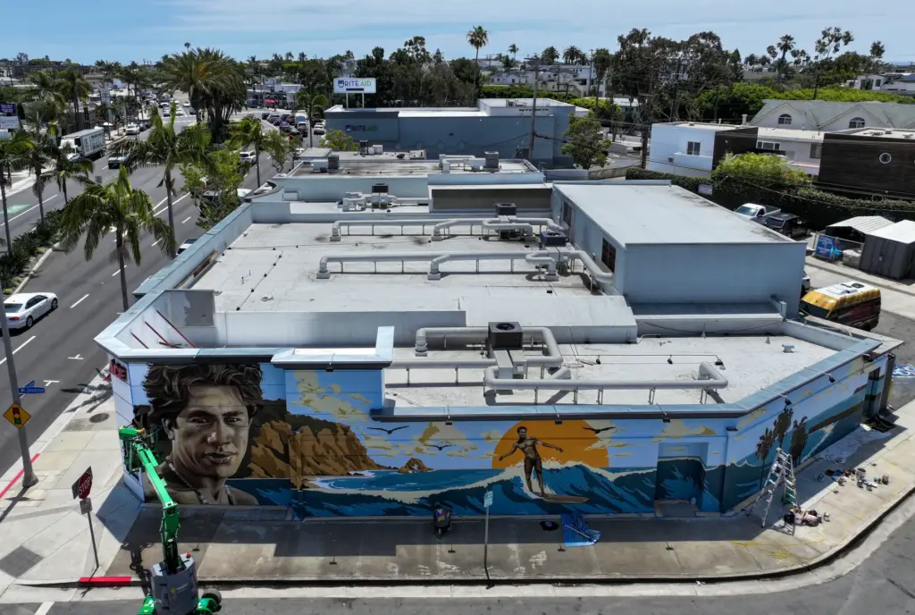 Artist Jack Stricker puts the finishing touches on a mural...